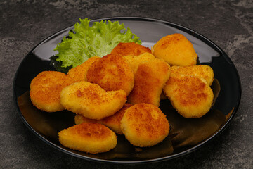 Fried chicken nuggets served salad leaves