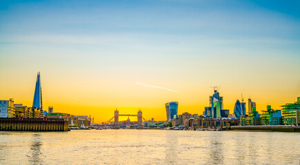 Fototapeta premium London skyline at sunset including Tower Bridge and skyscrapers at financial district