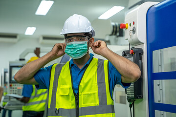 Factory engineer with face mask protect from Coronavirus or COVID-19,Concept of help and support and collaboration together to overcome epidemic of Coronavirus or COVID-19.