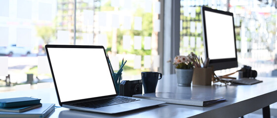 Side view of modern multiple devices mockup on white office table.