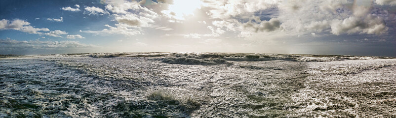 Stomy panorama over stormy sea with big foamy waves and dramatic sky