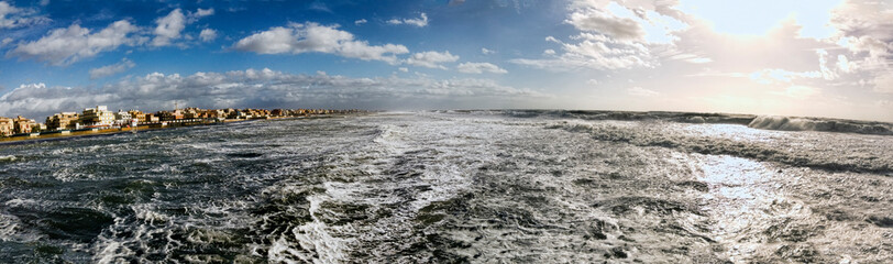 Stormful panorama with furious sea and stormy weather with dangerous big waves crashing powerful on the coast of Rome