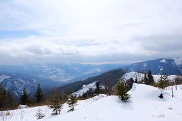 Fototapeta na wymiar Winter mountain views on red ridge trail from Certovica - Sedlo za Lenivou - Sedlo Homolka during snowshoe tours in Low Tatras in Slovakia