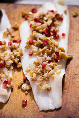 Halibut raw fish with pomegranate and walnuts, oven ready 