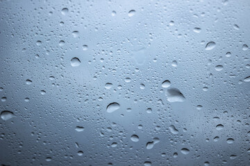 Water drops on glass ,light background