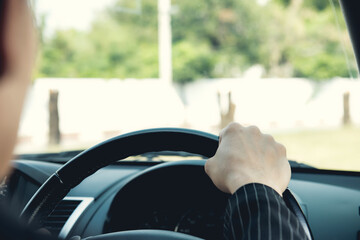 man driving car, steering wheel of a car, vintage color tone, focus at finger