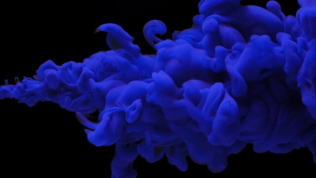 abstract background dense thick cloud of blue colored paint,ink jet breaks into the water on black, underwater explosion