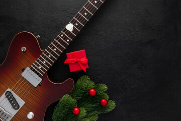 Christmas music. Flat lay composition with guitar and fir tree branches
