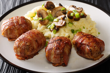 Delicious Danish Slavink served with potatoes, mushrooms and green onions close-up on the table. horizontal