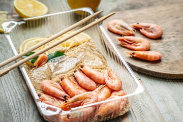 Appetizing and delicious ready made dish of shrimps and rice in a plastic container. Concept of frozen food that you can fast cooking and have dinner like in a restaurant at home