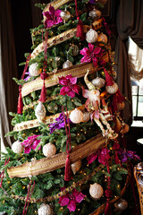 Christmas tree decorated with toys and garlands in retro style.