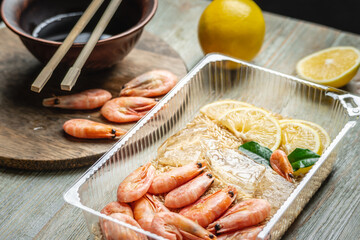 Appetizing and delicious ready made dish of shrimps and rice in a plastic container. Concept of frozen food that you can fast cooking and have dinner like in a restaurant at home