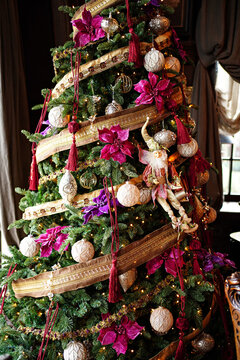 Christmas tree decorated with toys and garlands in retro style.