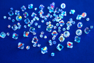 Glass multicolored rhinestones beads on a blue background.