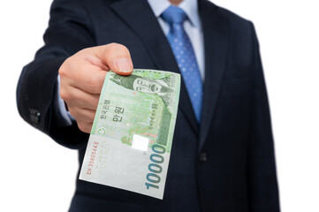 Businessman holding Korean currency in hand on white background.
