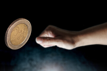 Fototapeta premium flips up a two euro coin, selective focus