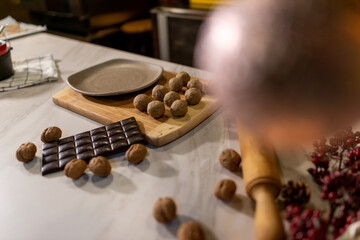 Vegan chef girl cooking sweets in christmas kitchen making chocolates and cookies for christmas