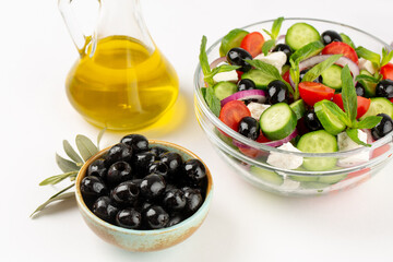 Olives and olive oil and vegetable salad in studio