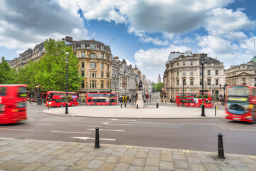 St. Charles roundabout at Trafalgar square with blurry red buses in London
