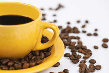 Black coffee in a yellow cup on a white background
