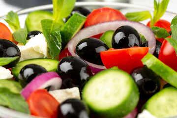 Olives and olive oil and vegetable salad in studio