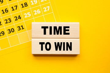 TIME TO WIN inscription on CUBES , yellow pen on a yellow background. a bright solution for business, financial, marketing concept