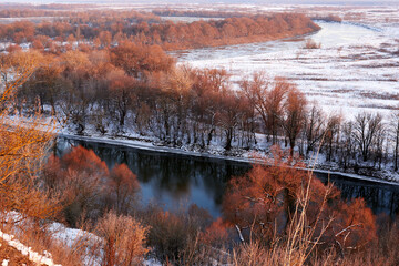 Beautiful river and snow-covered valley in winter.