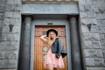 Girl in black hat posing on the street in the old city, copy space