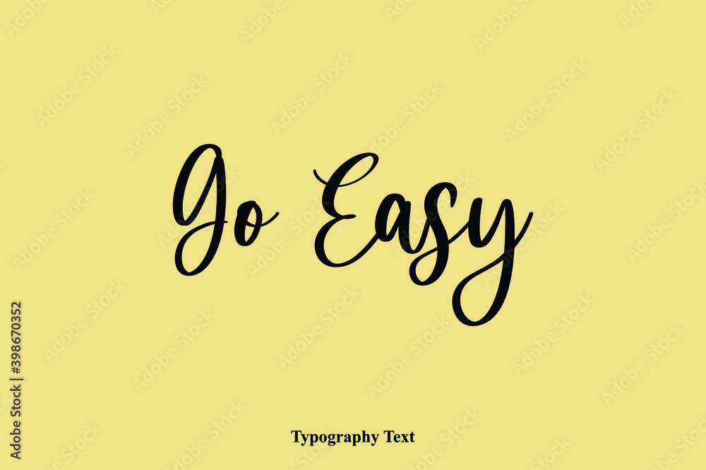 Fototapete go easy typescript cursive handwriting calligraphy phrase on yellow background