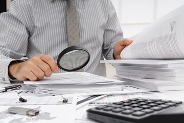 business concept - businessman's working table close view, checks financial reports, writes and counts
