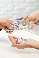 Woman changing watches and jewellery for money 