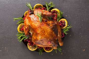Oven baked large duck or chicken on dark table with copy space