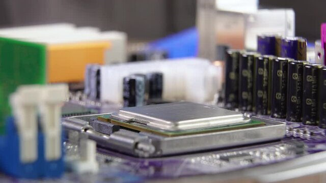 High tech. The process of installing a processor on a computer motherboard. Close-up 4K