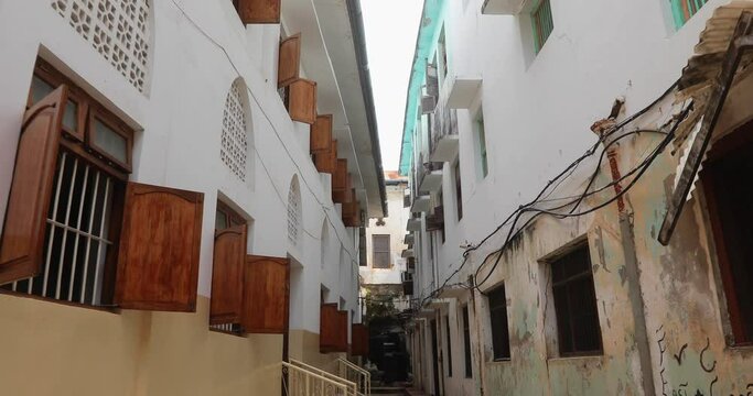 
Walk through the beautiful narrow streets of Stone Town in Zanzibar. Beautiful street of the old town with architecture, doors, windows.