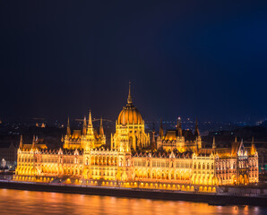 Side view of Hungarian Parliament illuminated at night in Budapest