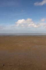 Fototapeta na wymiar North Sea beach with mud flats at low tide