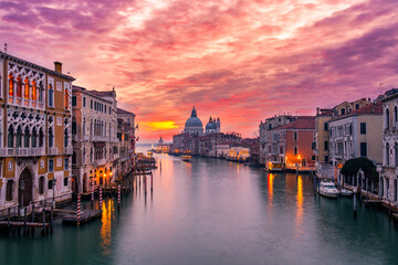 Fototapeta na wymiar Beautiful sunset view of Grand Canal and Basilica Santa Maria della Salute in Venice, Italy