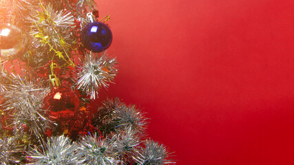 Christmas tree with toys, balls, garlands and lights, new year background. Copy space. Place for text