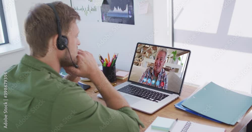 Canvas Prints Caucasian man on laptop video chat wearing phone headset at home