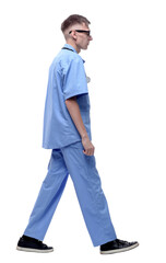 Naklejka premium side view. serious young doctor striding forward.