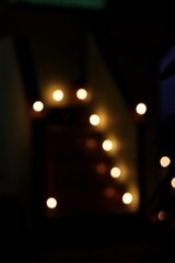 Bokeh lights of Dev Diwali in a temple in Varanasi. Colourful lights during Diwali in India. Blur background with small bulbs.
