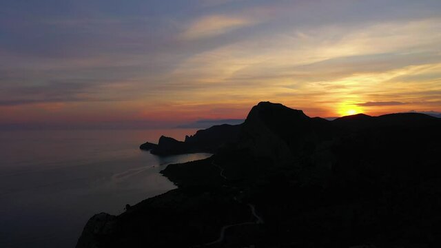 Mountain Sokol and Capchik Cape at Sunset. Black Sea. Crimea, Russia. Aerial View. Drone Flies Sideways