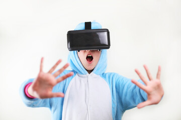 little girl in unicorn pajamas with virtual reality headset. on white background