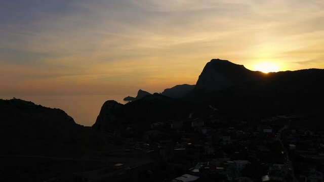 Mountain Sokol and Capchik Cape at Sunset. Black Sea. Crimea, Russia. Aerial View. Drone Flies Forward