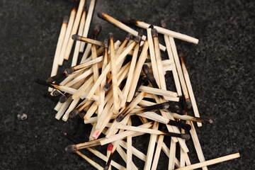 Heap of burnt matches on granite table