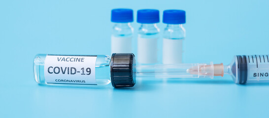 COVID-19 Vaccine vial and injection Needle Syringe against Coronavirus infection in hospital laboratory. Medical, health, Vaccination and immunization concept