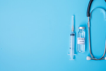 COVID-19 Vaccine vial, injection Needle Syringe and Stethoscope against Coronavirus infection in hospital laboratory. Medical, health, Vaccination and immunization concept