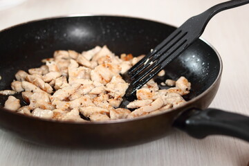 Fried chicken fillet in skillet. Making Chicken and Egg Galette Series.