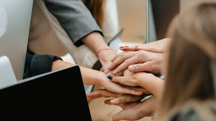Obraz na płótnie Canvas close up. business team joining their hands over the Desk.