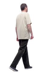 in full growth. a man in a light t-shirt striding forward.